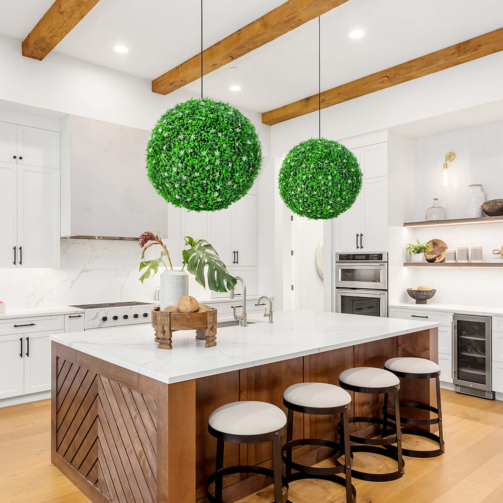 Two 19.5-inch faux boxwood topiary balls in a kitchen setting, adding vibrant greenery with effortless maintenance.