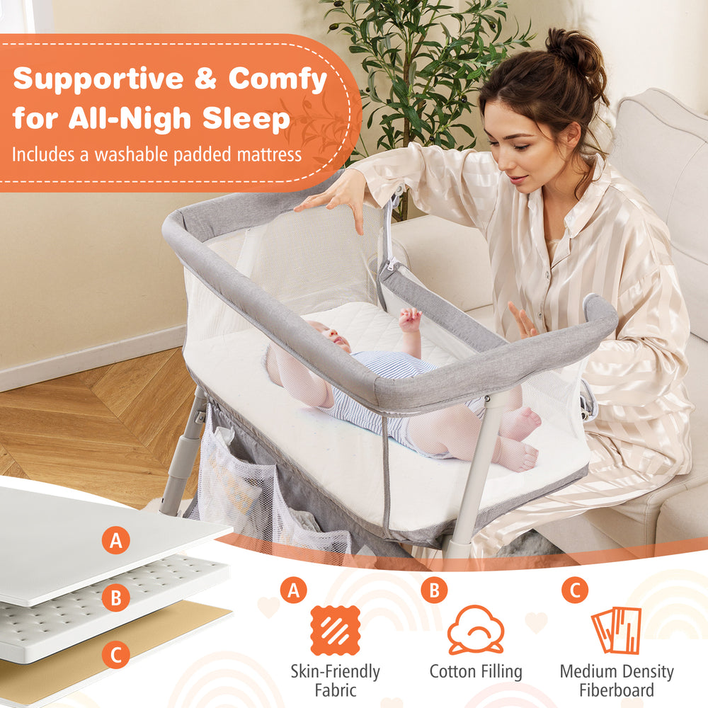 Baby bassinet bedside crib in gray with adjustable height, mesh sides, and comfy mattress for safe sleep.
