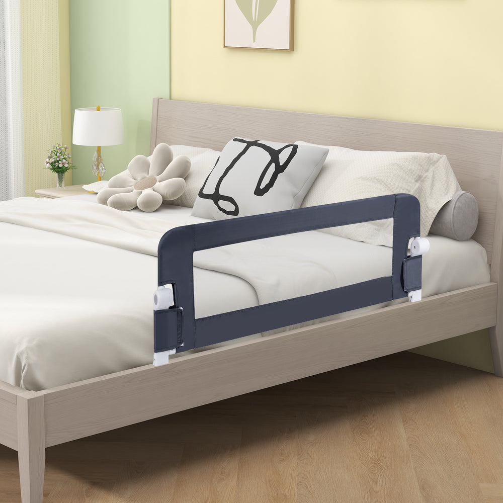 Foldable gray bed rail for toddlers with soft padding, adjustable strap, and T-shaped legs for enhanced stability.