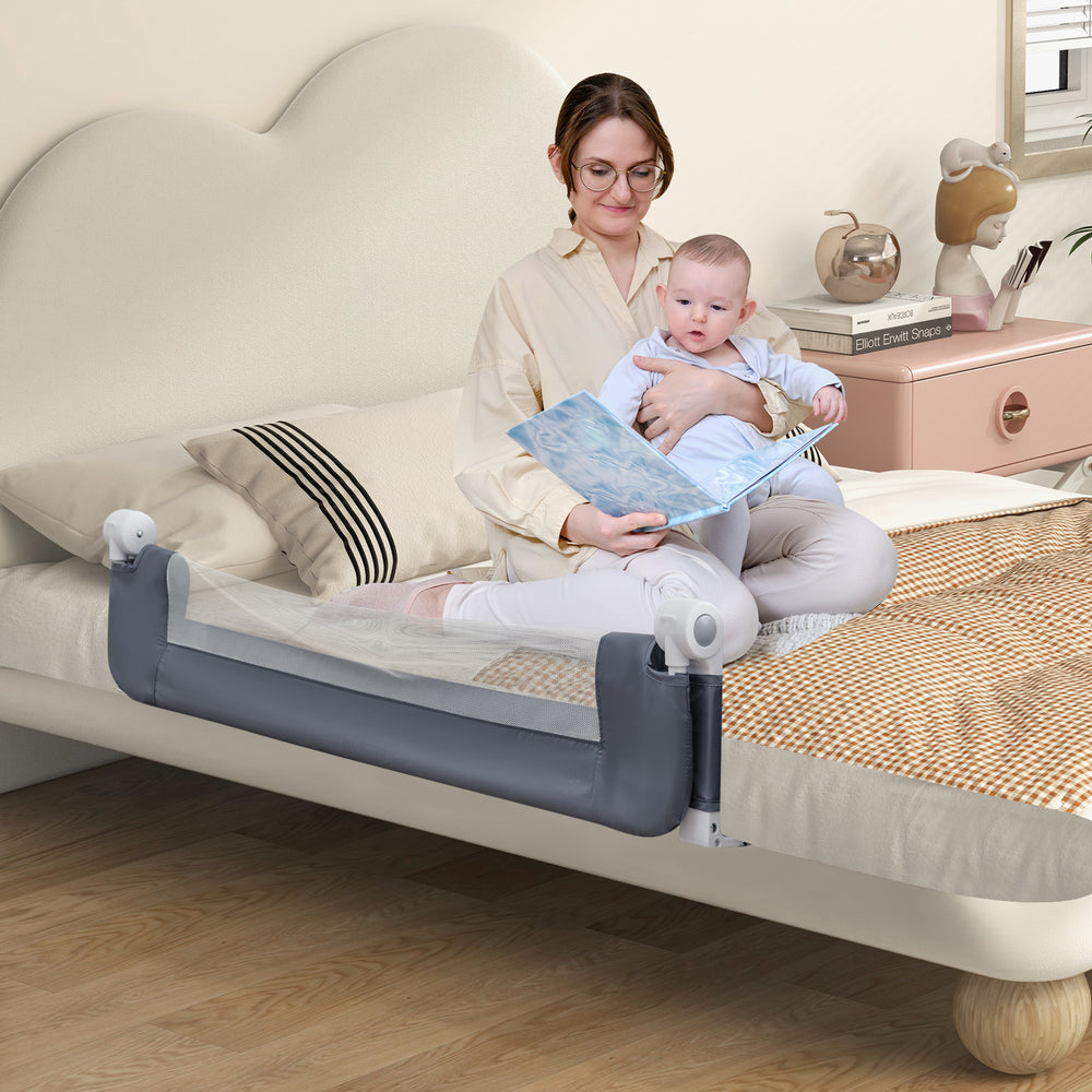 Foldable gray bed rail for toddlers with soft padding, adjustable strap, and T-shaped legs for added stability.