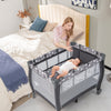 Portable gray baby playard with changing table, mesh sides, and music box, ideal for easy observation and mobility.