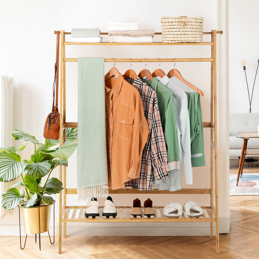 Bamboo clothing rack with hanging rod, 2-tier shelves, and side hooks, perfect for bedroom or entryway storage.