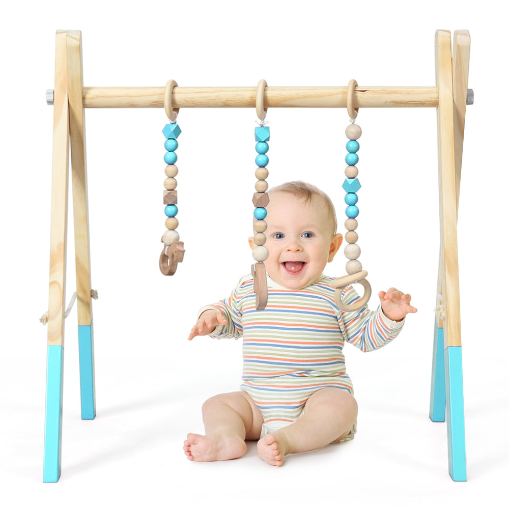 Wooden baby activity gym with hanging teething toys in blue, promoting physical and mental development for infants.