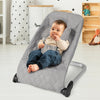 Light gray baby bouncer seat with ergonomic design and 5-point harness, perfect for soothing infants.