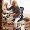 Height adjustable drafting chair with flip-up arms, ergonomic backrest, and breathable mesh, ideal for creative.