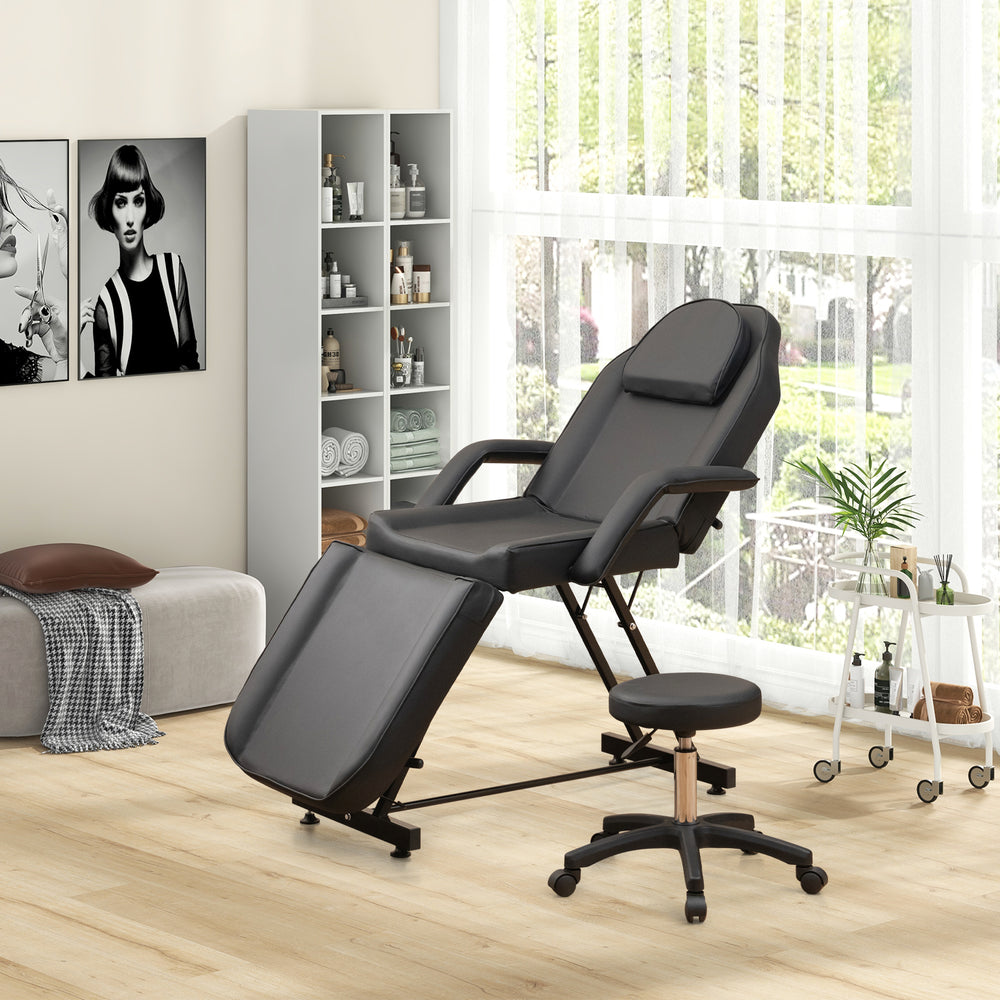 Facial chair set in black with removable headrest and armrests, featuring a towel rack for spa and massage use.
