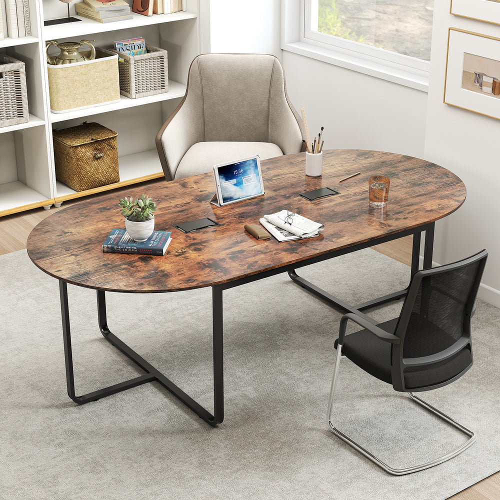 Oval industrial executive table in rustic brown with dual cable holes, suitable for meetings of up to 12 people.