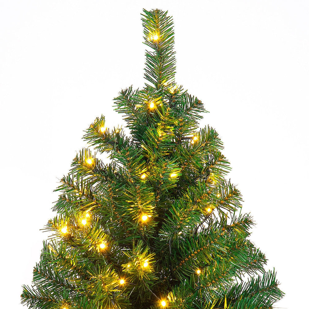Top view of a 9-foot pre-lit PVC artificial Christmas tree with 700 warm white LED lights, perfect for festive indoor.