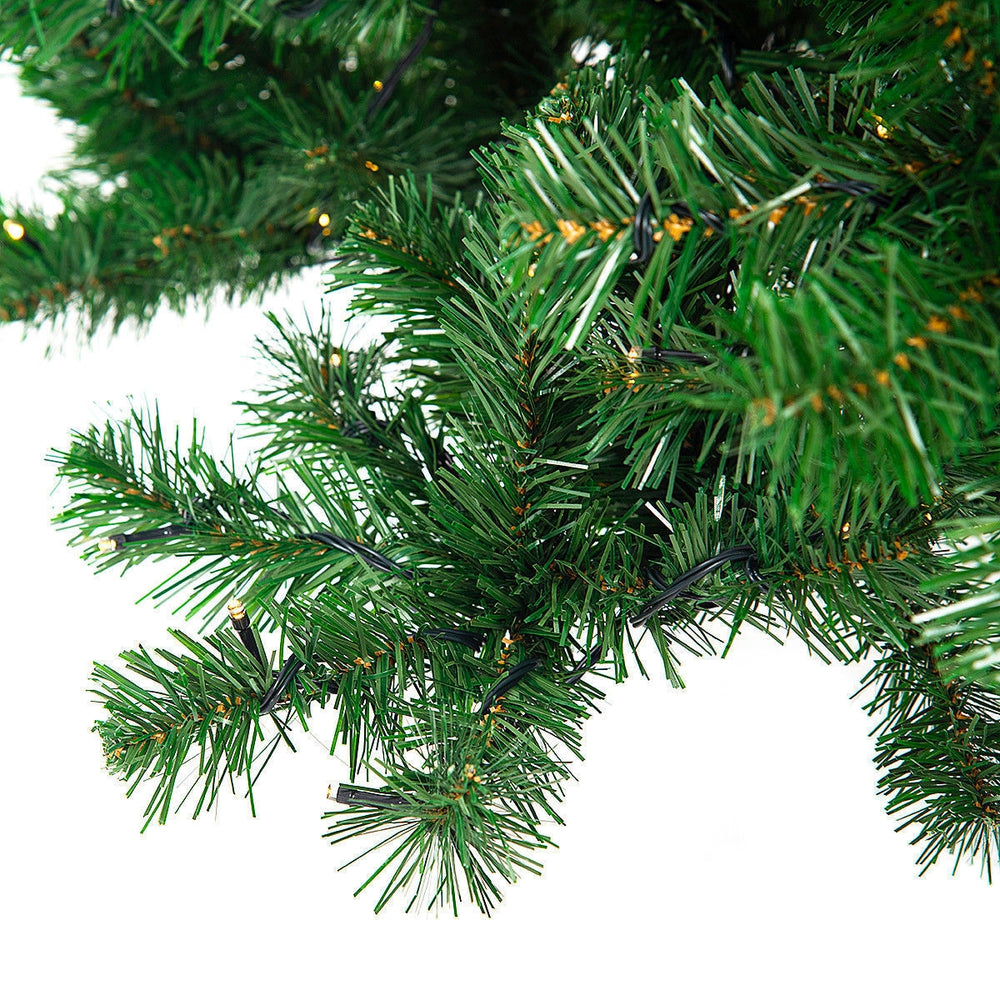 Close-up of the 9 ft pre-lit PVC artificial Christmas tree branches with 700 LED lights, perfect for festive indoor.