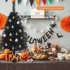 Mini black artificial tree with 116 branch tips and triangular base, designed for Halloween and Christmas celebrations.