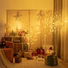 Pre-lit 4 ft white twig birch tree with 48 LED lights, creating a warm holiday atmosphere for indoor decoration.
