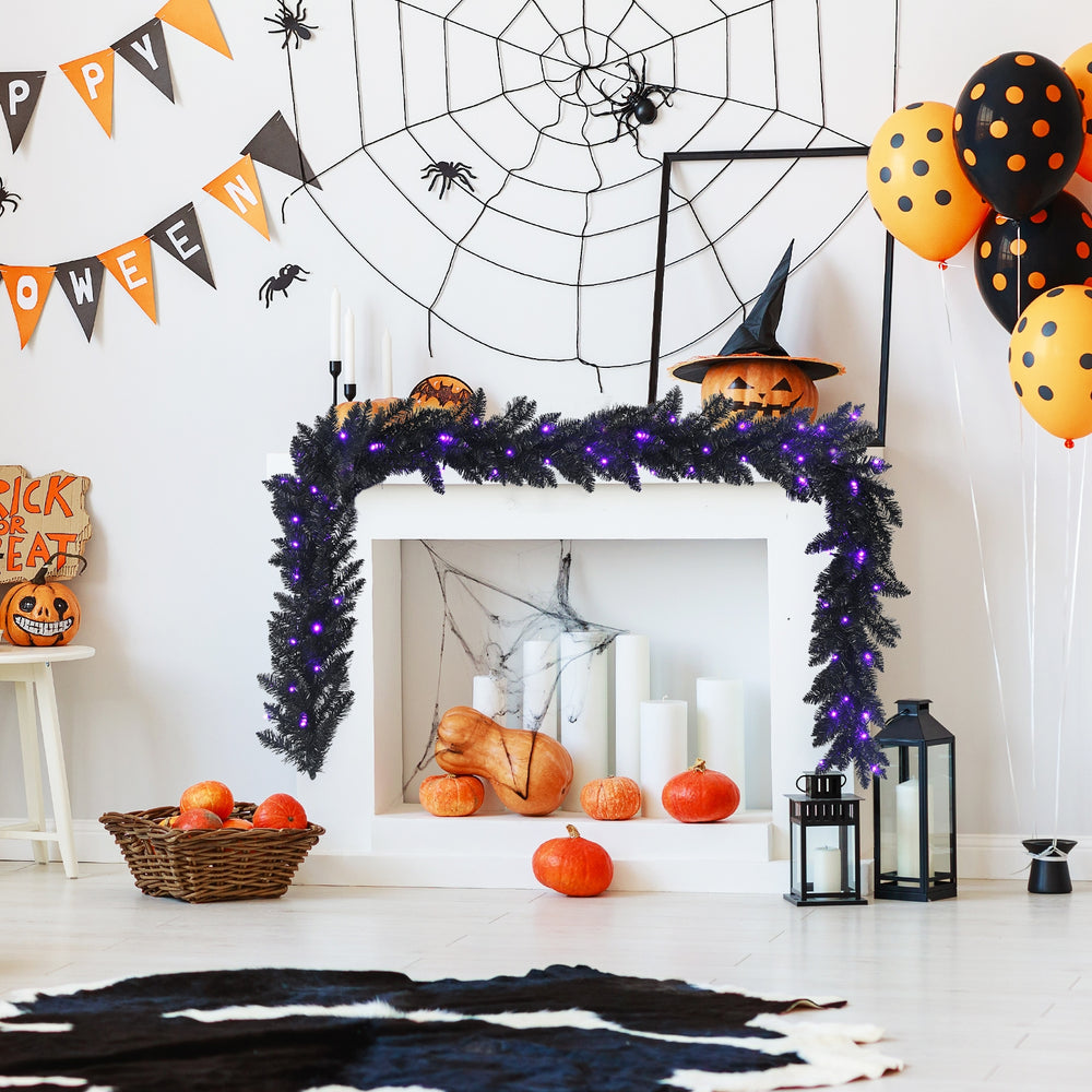 Flexible 9-foot black Halloween garland with 50 purple LED lights, designed for creative indoor and outdoor spooky.