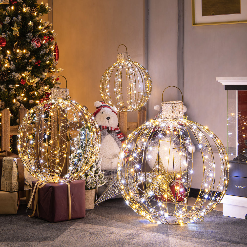 Three decorative golden LED light balls with warm and white lights, perfect for festive indoor or outdoor displays.