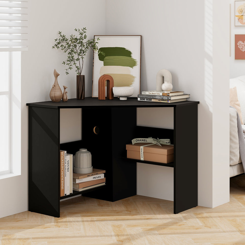 Black corner computer desk with triangle design, storage shelf, and cable management for a tidy workspace.