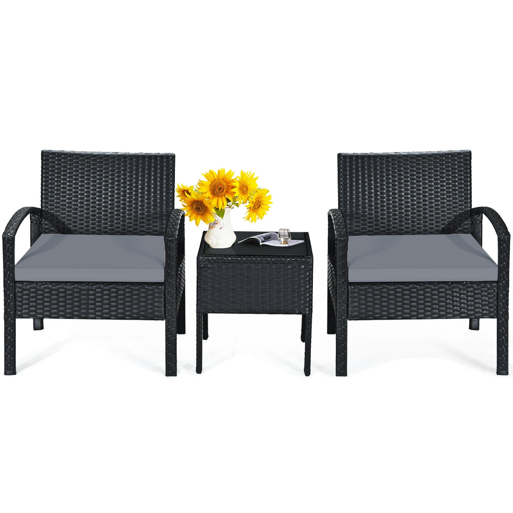 Two gray cushioned rattan chairs and a small table, perfect for outdoor patio relaxation and conversation.