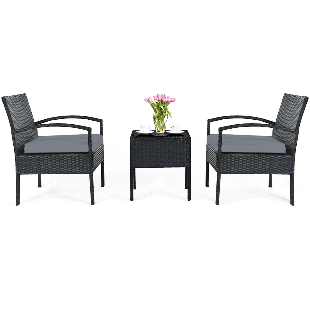 Three-piece outdoor rattan patio conversation set with gray seat cushions, ideal for backyard or balcony relaxation.
