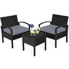 Three-piece outdoor rattan patio conversation set with gray cushions, featuring a tempered glass table for stylish.