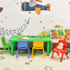 Colorful plastic table and four chairs set with rounded corners, perfect for kids' playroom or learning activities.