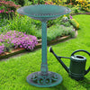 Green pedestal bird bath feeder made of weather-resistant resin, perfect for attracting birds in your garden.