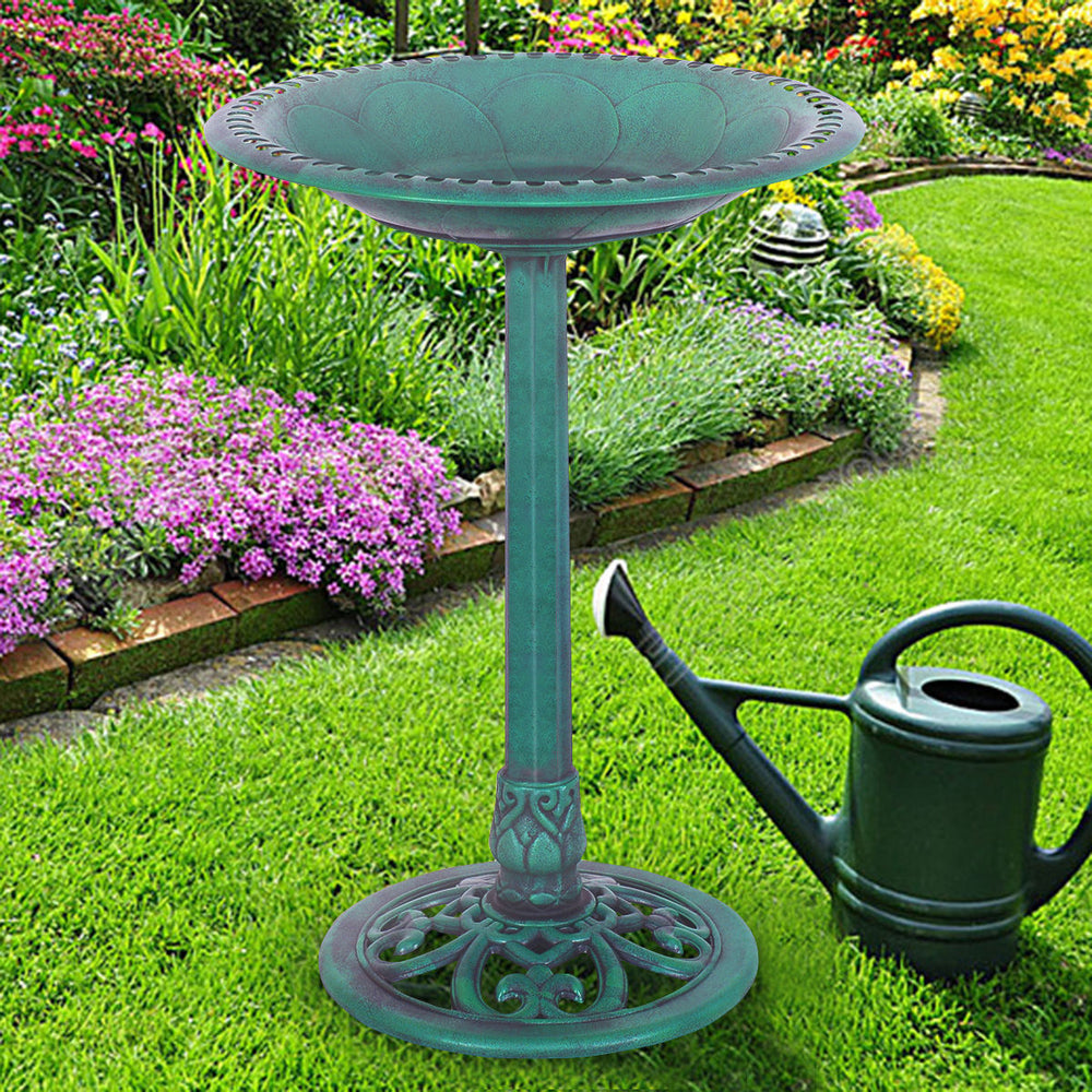 Green pedestal bird bath feeder made of weather-resistant resin, perfect for attracting birds in your garden.