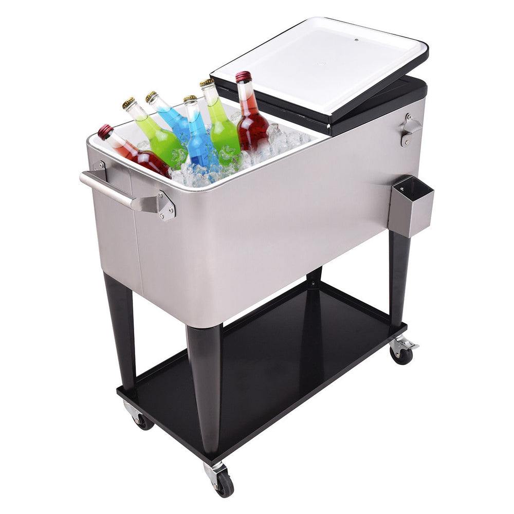 Stainless steel 80 quart rolling beverage cooler with two access lids, ice-filled, and bottom shelf for storage.