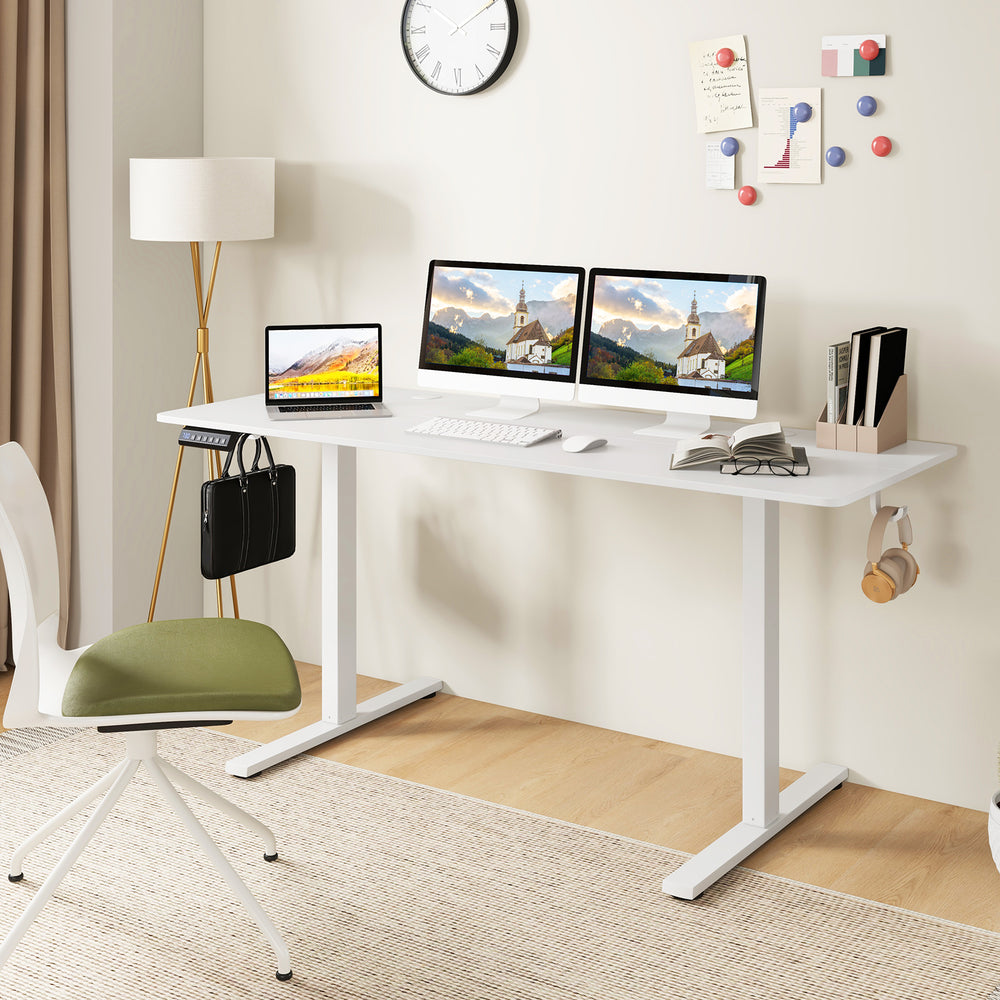 Electric standing desk in white with dual monitors, featuring adjustable height, cable management holes, and hanging.