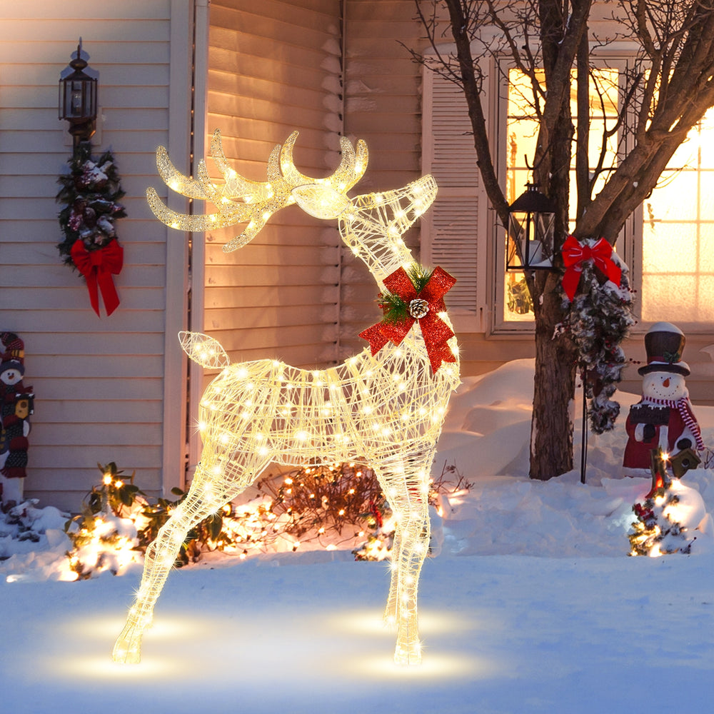 Lighted standing reindeer with 120 LED bulbs, festive bow, and waterproof tinsel, perfect for outdoor Christmas.