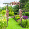 Garden arbor with trellises for climbing plants, featuring a floral design, ideal for weddings and outdoor events.
