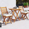 Folding chair table set featuring acacia wood, soft seat cushions, and slatted design, ideal for balcony or poolside.