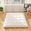 Beige full-size futon mattress floor sleeping pad with quilted design, ideal for camping, yoga, or kids' play.