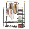 Rolling garment rack with height adjustable golden rods, featuring shelves for storage and lockable wheels for easy.