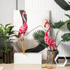 Two pink flamingo garden statues made of rustproof metal, designed for charming outdoor decoration and stability.