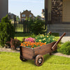 Wooden wagon planter box with wheels, featuring vibrant flowers, ideal for outdoor decoration and plant display.