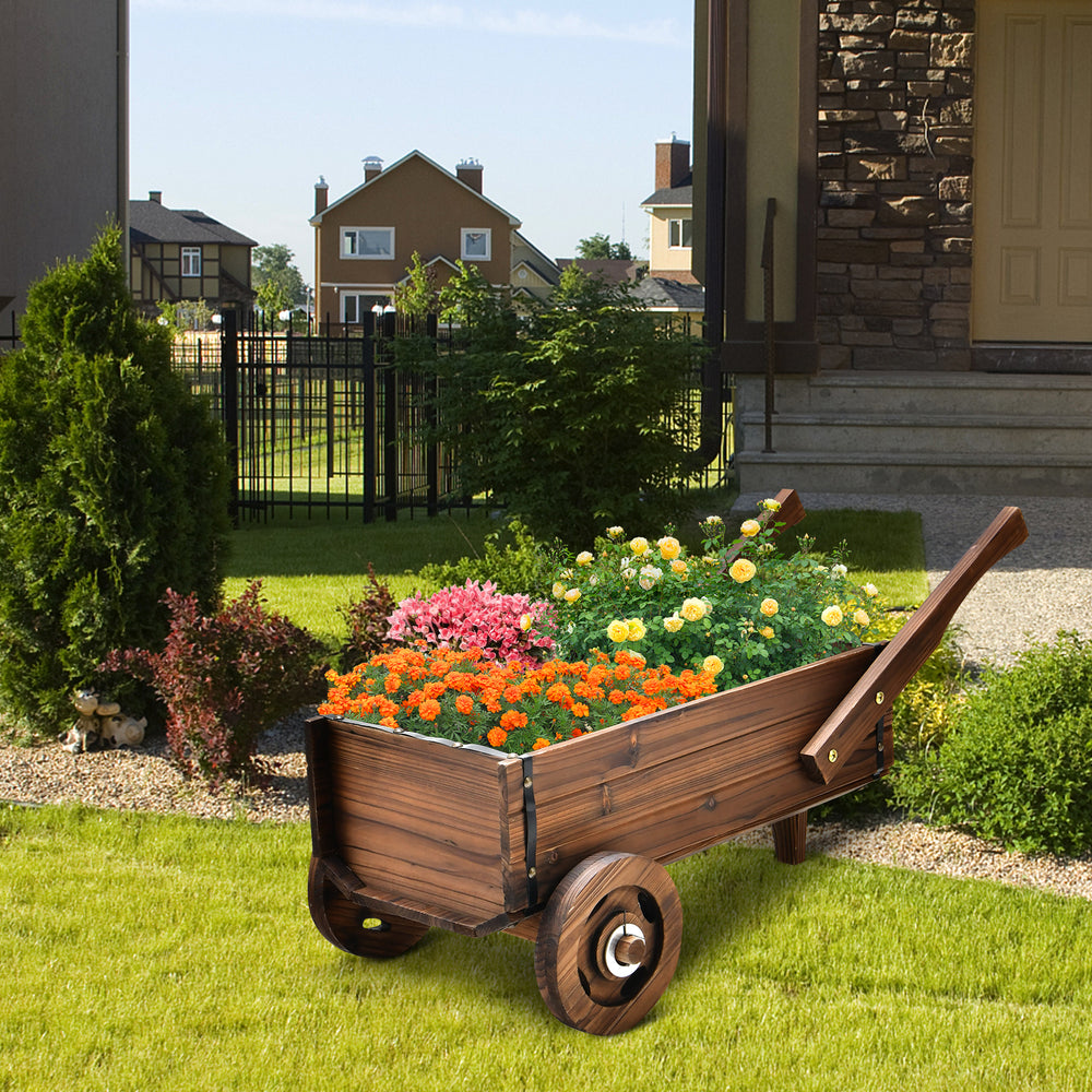 Wooden wagon planter box with wheels, featuring vibrant flowers, ideal for outdoor decoration and plant display.