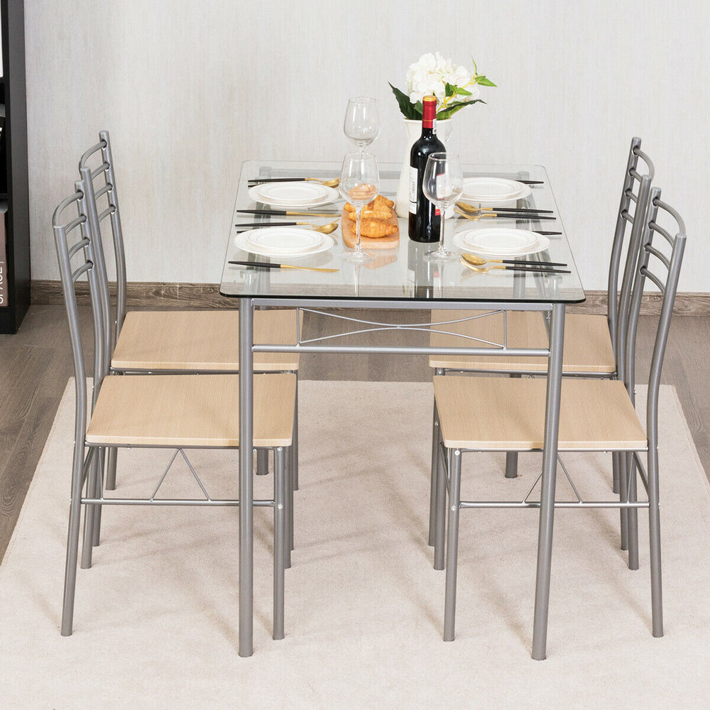 Dining set featuring a glass table and four metal chairs, perfect for modern kitchens and restaurants.