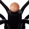 Close-up of the vintage metal coat hat tree stand showing the wooden top ball and sturdy black steel construction.