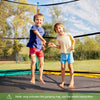 Two children jumping on a high-elastic PP replacement jumping mat for a 12 ft trampoline, perfect for outdoor fun.