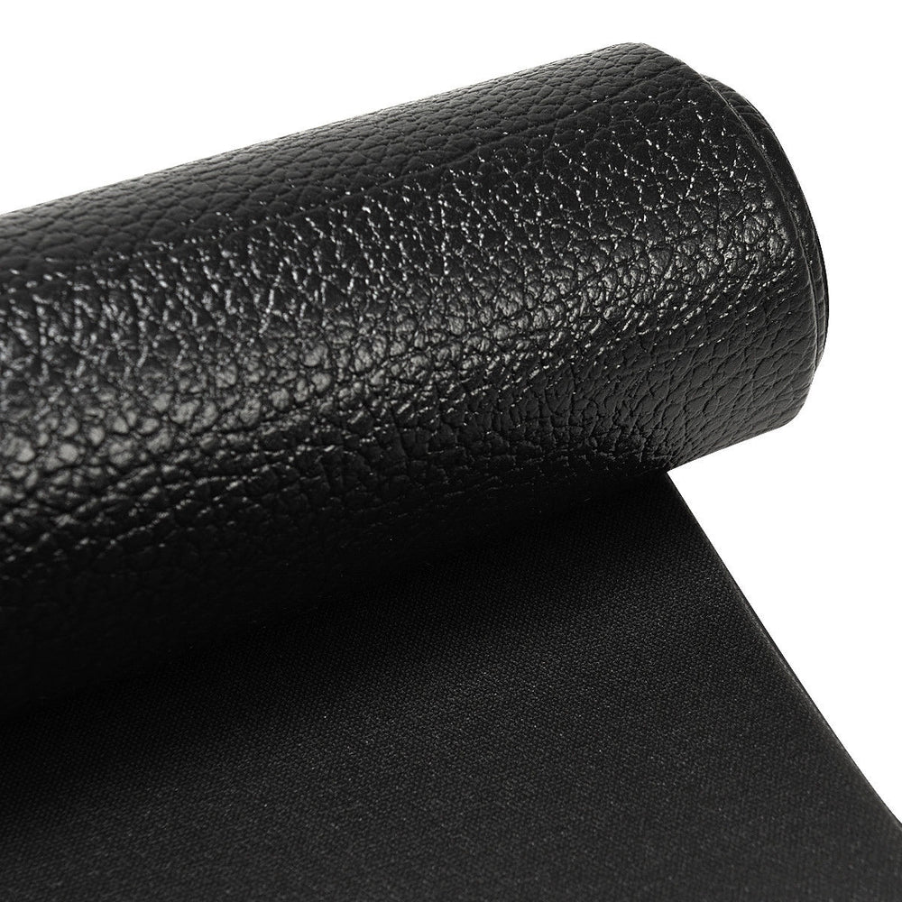 Close-up of a black high-density PVC equipment mat, ideal for home gym use, featuring a textured non-skid surface.