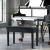 Black solid wood piano bench with PU leather padding and storage compartment, ideal for music settings.