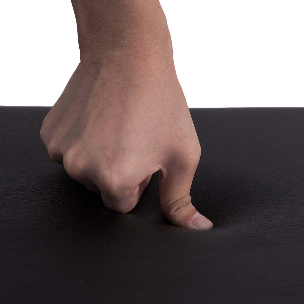 Close-up of the PU leather surface of a black piano bench, showcasing its padded texture and durability for comfortable.