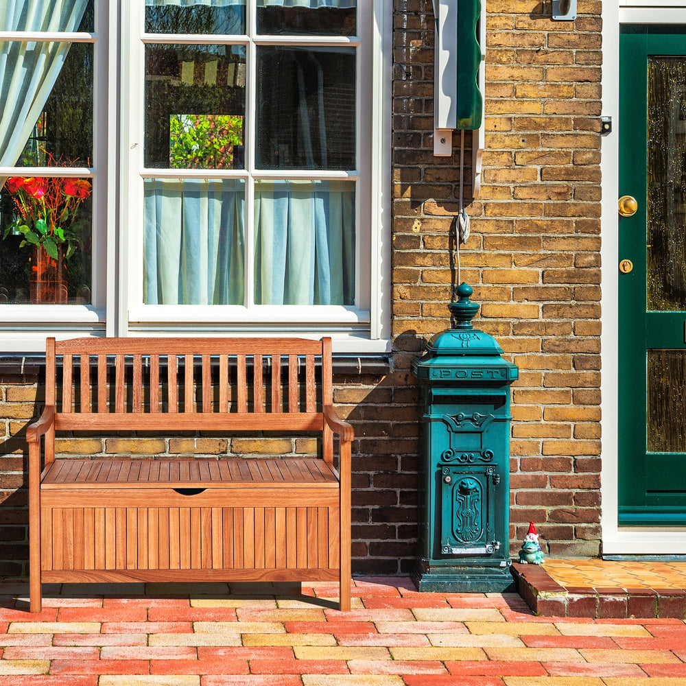 Wooden storage bench in natural teak color with a flip-top lid, perfect for patio or garden seating and storage.