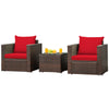 Two red-cushioned patio chairs and a glass-top table, made of durable rattan, perfect for outdoor relaxation.