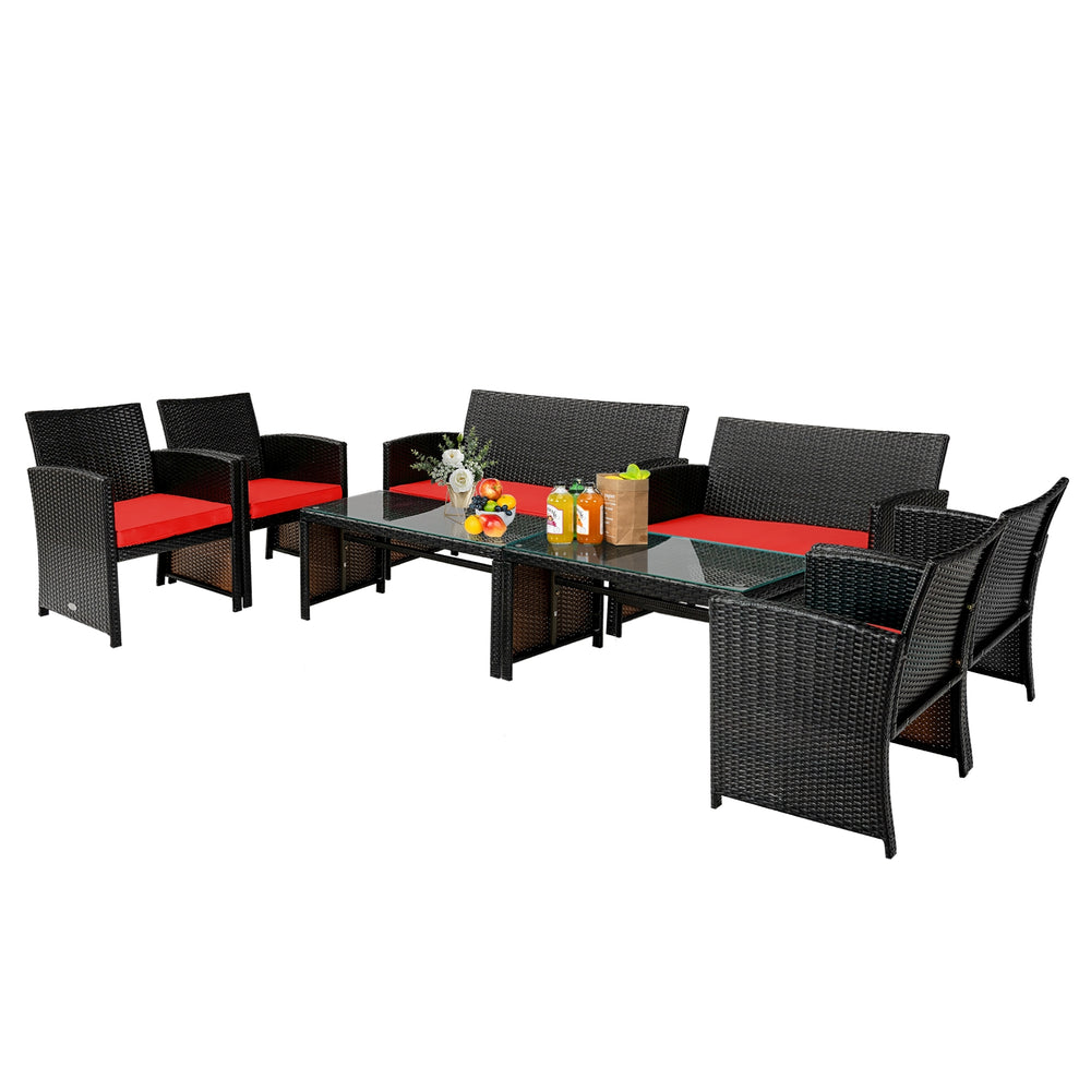 Four-piece patio rattan furniture set with red cushions, including a loveseat, two chairs, and a tempered glass coffee.
