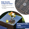 Tempered glass tabletop of the 6-piece patio rattan furniture set, featuring a smooth surface for easy cleaning.
