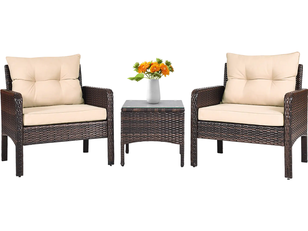 Outdoor patio rattan conversation set with beige cushions, featuring two chairs and a glass-top table for backyard.