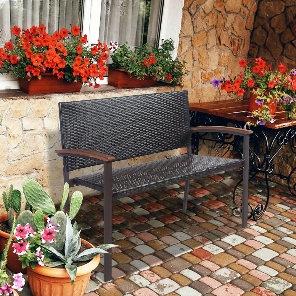Outdoor patio rattan wicker bench with acacia wood armrests, perfect for garden seating and durable against weather.