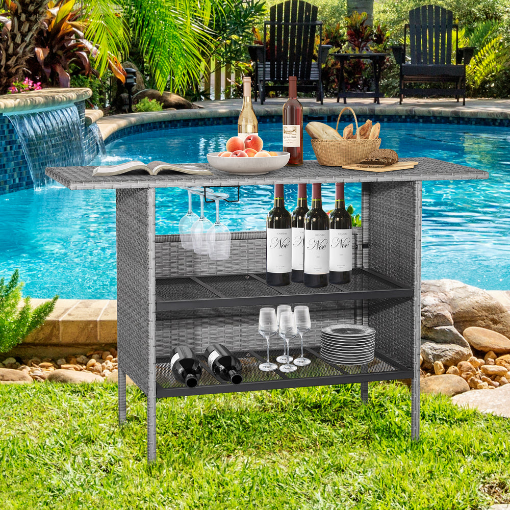 Outdoor patio wicker bar table with metal shelves, 55-inch tabletop, and stemware racks, ideal for poolside gatherings.