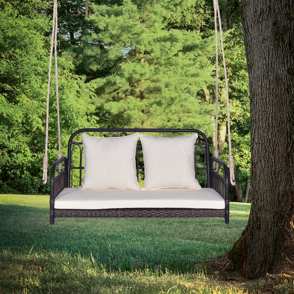 Wicker hanging porch swing with white cushions, durable PE wicker, suitable for outdoor use, holds up to 880 lbs.