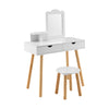 Kid vanity table chair set in white with mirror, two large storage drawers, and natural pine wood legs for stability.