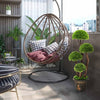 Decorative artificial cedar topiary tree with rattan trunk, featuring four layered balls for a lifelike indoor/outdoor.
